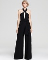 A beloved retro-silhouette makes a glamorous comeback for fall--this glamorous Alexis jumpsuit offers a flattering halter-back neckline with an elegant wide-leg drape for a dramatic look disguised in an effortless one-piece silhouette.