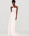 In crinkled silk chiffon, Amsale's long dress lends a statuesque look in a strapless-meets-one-shouldered silhouette.