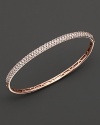 Pavé diamond bangle in 14 kt. rose gold. Hinged closure.