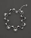 A bold sterling silver bracelet, gleaming with black onyx, is an elegant showcase for Di MODOLO's iconic Triadra design.