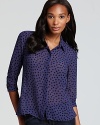 See, spot, style: this BCBGeneration shirt is polka dot perfection, with a classic collar and rounded hem fit for work wear.