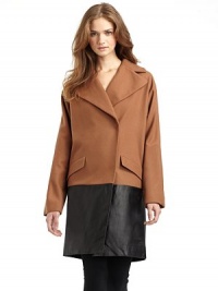 THE LOOKNotch lapelConcealed front snap closureLong sleevesFront flap pocketsExtended leather hemTHE FITAbout 36 from shoulder to hemTHE MATERIAL80% wool/20% nylonTrim: LeatherFully linedCARE & ORIGINDry clean by leather specialistImported