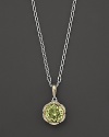 Diamonds, set in sterling silver and 18K yellow gold, frame a faceted round of lemon quartz. By Tacori.