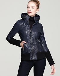 Biker-chic to get your haute racing, this Mackage jacket features a wide, round stand collar with a zip-out hood and is finished with extra-long ribbed cuffs and hem.