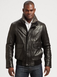 This classic bomber style is perfect for any occasion, shaped in supple leather with a removable genuine dyed shearling collar for the ultimate experience of warmth and comfort.Zip frontButtoned placketWaist flap pocketsRibbed knit hemFully linedAbout 27 from shoulder to hem LeatherDry cleanImportedFur origin: Portugal