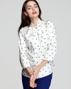 A scribbled dot print gives a modern touch to Shoshanna's luxe silk tie-neck blouse.