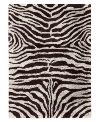 Exotic designs will be the pride of your decor. Adorned with zebra stripes in black and white, this Nourison rug has a marvelously soft and shaggy pile that's hand-tufted from premium-quality yarns. Beautiful in appearance and plush underfoot, this area rug creates an atmosphere of casual elegance. (Clearance)