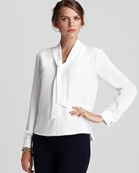 Brimming with modern romance, this T Tahari blouse flaunts a generous tie collar and sheer silhouette for a stunning feminine style.