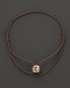 A tricolor gold pendant with diamonds accents this modern leather cord bracelet from Georg Jensen.