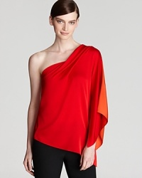 Fluid silks cascades the length of a one-shoulder Elie Tahari blouse for a striking feminine silhouette.