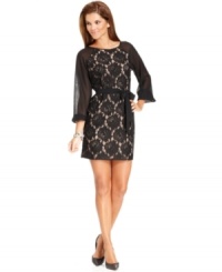 Sheer sleeves and a striking floral lace overlay make this petite dress from Jessica Howard shine. A self-tie sash cinches the silhouette for a flattering effect.