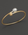 A gleaming freshwater pearl and a gorgeously textured gold bead meet on this 18K yellow gold bangle with diamonds. From the Africa Collection.