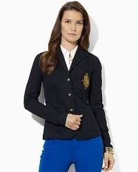 A wardrobe essential, a chic three-button blazer is crafted in stretch denim and finished with a signature crest at the chest.