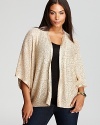 This graceful open-weave DKNYC Plus shrug features shimmering sequin embellishment to brighten up an LBD or basic tank.