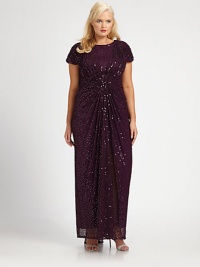 Sequins adorn this gown for an instantly glamorous look. The gathered and ruched details ensure a flattering silhouette.Round neckShort sleevesGathered and ruched detailsFully linedAbout 53 from natural waistNylonDry cleanImported