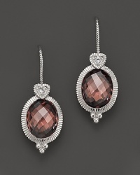 A faceted raspberry crystal is framed in glinting sterling silver. Designed by Judith Ripka.