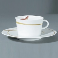 For over two centuries Raynaud has created unique Limoges porcelain, with a marked preference for relief shapes and generously colored and gilt decorations. Metamorphoses is a striking pattern of red and gold with a butterfly motif.