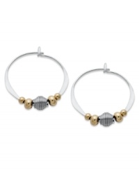 Petite hoops pop with the addition of gold tone brass and silver beads. Set in sterling silver. Approximate diameter: 3/4 inch.