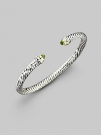 From the Color Classics Collection. The signature Yurman cable, in a graceful bangle capped with faceted peridot domes and accents of 14k gold. Peridot Sterling silver and 14k yellow gold Cable, 5mm Diameter, about 2¼ Imported