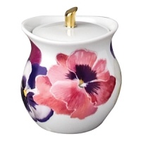 Pensees sugar bowl by Bernardaud. This lively, luxurious collection is sure to transform your table into a celebration of spring. The floral watercolor pattern features delicate, multicolored pansies that appear to be strewn across the surface of each piece.