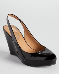 Elie Tahari's glossy Alexia wedges showcase a classic slingback silhouette and timeless style.