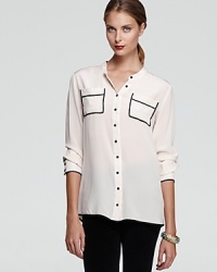 Spun from silk, this elegant Gold Hawk blouse repositions the classic button-down shirt with sleek contrast trim and abstract patch pockets.