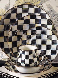 A charming way to add color and personality to the dinner table, crafted in a checkerboard juxtaposition of ivory and onyx with bronzed stainless steel trim. Enameled steel 12 diam. Dishwasher safe Made in USA 