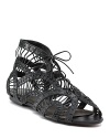 The airy, lacy look of these flat sandals is anchored by tough black leather. By Joie.