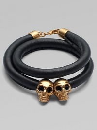 Two iconic, crystal accented skull beads on a luxurious, wrapped leather cord. Leather cordSilvertone brassCrystalsLength, about 14Lobster clasp closureMade in Italy