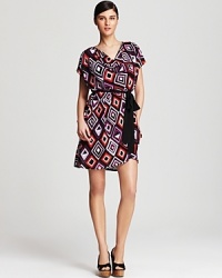 Blending bold colors with graphic prints, this DKNYC dress paves the way for a season of endless style. Play up the flirty silhouette with lofty wedges.