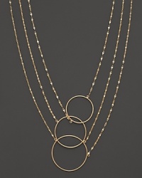 Interlocking circles and gleaming chains of 14K yellow gold. By Lana.