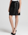 Luxe in leather, this Elie Tahari skirt is sweet with a side bow and edgy with an exposed zip closure.