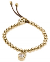 Michael Kors' beautifully-beaded padlock bracelet is crafted in gold tone steel with an adjustable brown leather clasp. Features a glass accent at the padlock charm and a logo charm at the closure. Bracelet also stretches to fit wrist. Approximate diameter: 2-1/4 inches.