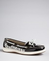 A classic nautical look goes on safari in Sperry Top-Sider's boat shoe accented with a zebra print. Clear sequins, metallic laces and patent leather make the look shine.