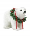 It's the holiday season, why not look your best? This playful polar bear cub celebrates this joyful time of year by donning a decorative wreath of holly, ivy and festive red ribbons.