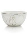 Sweet yet sophisticated, a loopy heart design sweeps across this white porcelain fruit bowl from Mikasa. Complete with a sparkling platinum rim, this flirty ribbon pattern captivates everyone at your dinner table.