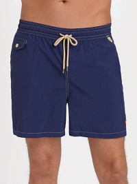 The classic Traveler swim short is rendered in sleek, quick-drying microfiber in a vibrant plaid pattern for cool, casual beach style.Elastic waistband with drawstring tie closureSide slash pocketsBack waist drainage grommetsBack flap patch pocketMesh liningInseam, about 4¾NylonMachine washImported