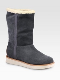 Ultra-cozy suede essential lined in shearling with grosgrain ribbon trim. Rubber heel, 1 (25mm)Shaft, 9¼Leg circumference, 13Pull-on styleSuede upper with grosgrain ribbon trimShearling liningRubber solePadded insoleMade in Italy