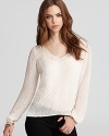 A sheer, wispy GUESS top, punctuated with an allover dot print--layer with a cami and top off your denim.