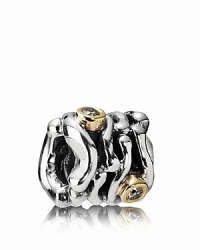 A swirling sterling silver PANDORA charm houses dramatic 14K gold bezel-set diamonds.