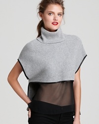 Take your look in a modern direction with this cashmere and wool sweater-top, replete with luxe leather trim and a sheer silk bodice to reveal your svelte silhouette.