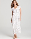 A wondrous floral print blooms across Eileen West's short-sleeve nightgown, laced with ribbon at the neckline.