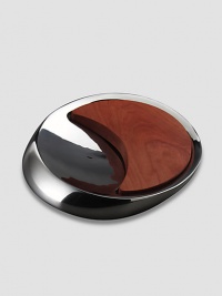 Inspired by the meeting of the sun and moon, this innovative metal alloy and cherry wood design combines a bowl and a board for both cutting and serving. Comes in Nambé blue gift box 14 Dia Hand wash gently Imported