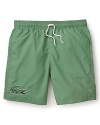 Take your classic preppy look to the beach. This comfy swim short sports an oversized Lacoste logo alligator at the right leg.