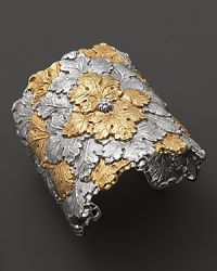 An ornate vine and leaf pattern is detailed in 18K yellow gold accents on Buccellati's statement-making cuff bracelet.