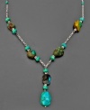 Accent any outfit with the radiant hue of turquoise. This earthy necklace combines sterling silver and rustic turquoise stones in with natural splendor. Measures approximately 18 inches long. Approximate drop: 2 inches.