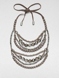 Multiple strands of faceted glass and wooden beads, suspended from a supple suede tie.Glass and wood beadsMetal-tipped suede tie closureDrop, about 14Made in Italy