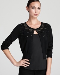 A constellation of beading beams from the neckline of a cropped DKNY cardigan for a chic statement.