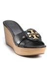 Tory Burch's bold, gleaming logo steals the show on these pebbled leather wedges.