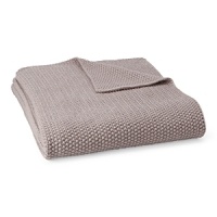 A cable knit throw adds a layer of warmth and luxurious softness.